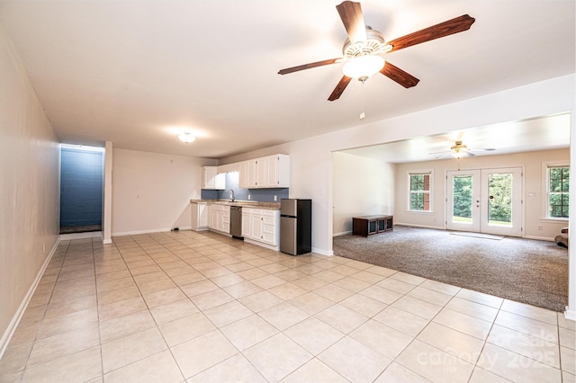 4010 Carlton Dr, Claremont, NC 28610 - kitchen with stainless steel appliances, open floor plan, light tile patterned floors, and a ceiling fan