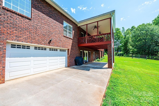 4010 Carlton Dr, Claremont, NC 28610 - view of side of property with concrete driveway, a yard, a ceiling fan, brick siding, and a garage