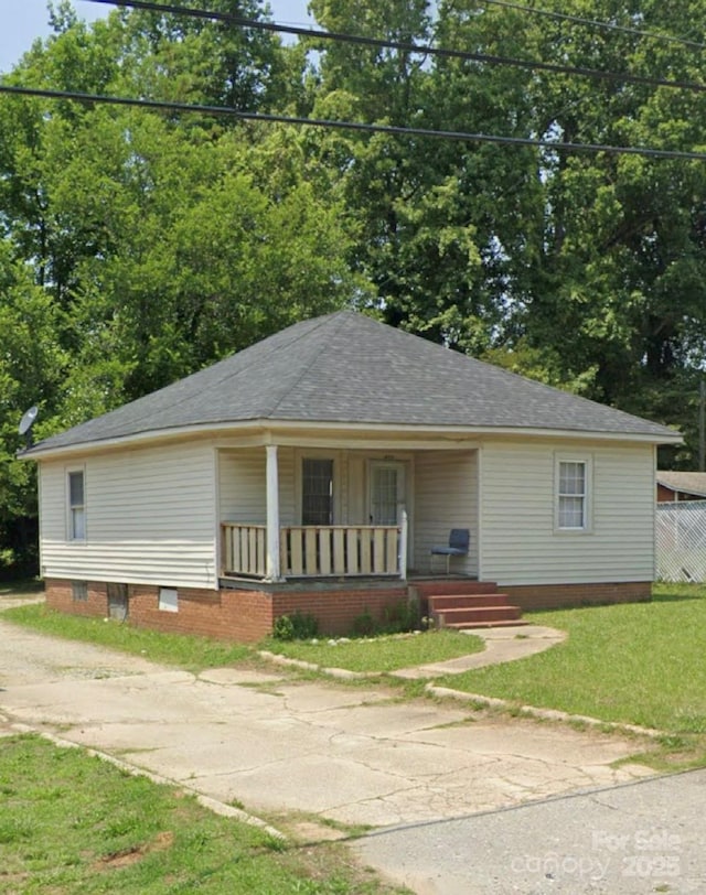 411 Klumac Rd, Salisbury, NC 28144 - bungalow with covered porch, a front yard, crawl space, driveway, and roof with shingles