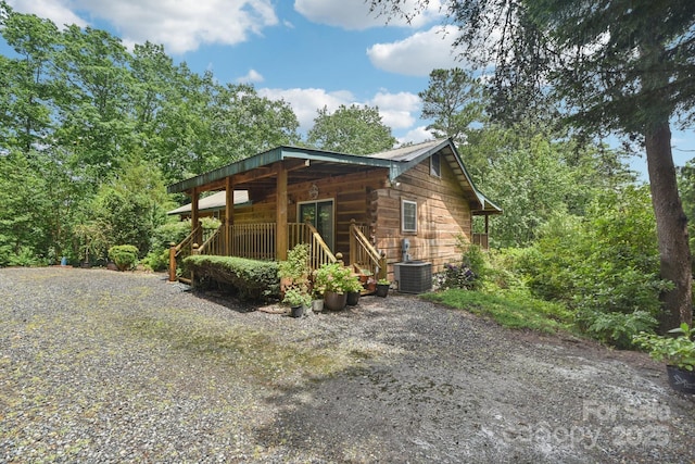 66 Ashlyn Ln, Tryon, NC 28782 - view of property exterior featuring a central AC unit and covered porch