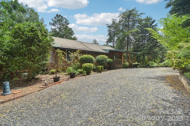 66 Ashlyn Ln, Tryon, NC 28782 - view of front facade with gravel driveway, a metal roof, and covered porch
