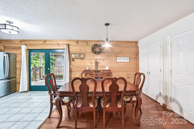 66 Ashlyn Ln, Tryon, NC 28782 - dining room with a textured ceiling, wooden walls, and french doors