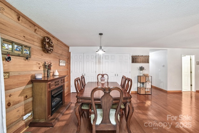 66 Ashlyn Ln, Tryon, NC 28782 - dining area featuring a textured ceiling, dark wood-type flooring, and wood walls