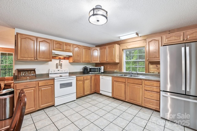 66 Ashlyn Ln, Tryon, NC 28782 - kitchen featuring stainless steel appliances, under cabinet range hood, a textured ceiling, plenty of natural light, and dark countertops
