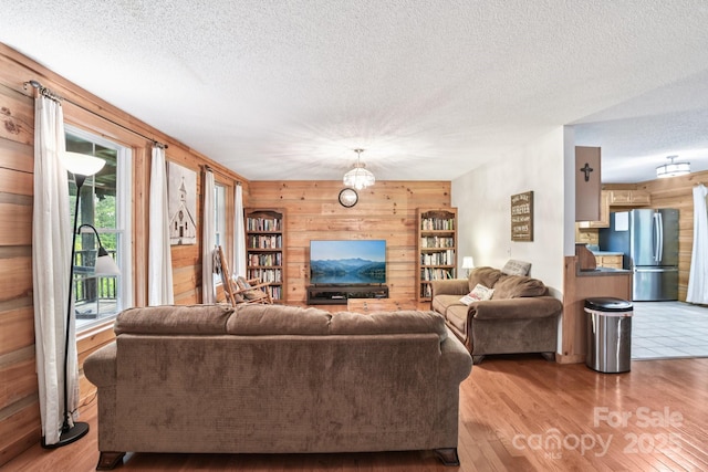 66 Ashlyn Ln, Tryon, NC 28782 - living room with wooden walls, wood finished floors, and a textured ceiling