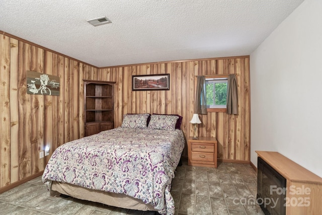 66 Ashlyn Ln, Tryon, NC 28782 - bedroom featuring wood walls and a textured ceiling