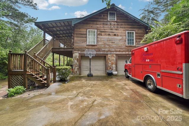 66 Ashlyn Ln, Tryon, NC 28782 - view of property exterior with stairway, a garage, stone siding, and concrete driveway