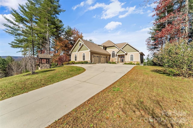 5346 Oak Crest Ln, Lenoir, NC 28645 - view of front of home with a garage, concrete driveway, a front yard, and stone siding