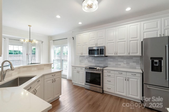 10418 Pullengreen Dr, Charlotte, NC 28277 - kitchen with appliances with stainless steel finishes, healthy amount of natural light, backsplash, white cabinetry, and recessed lighting