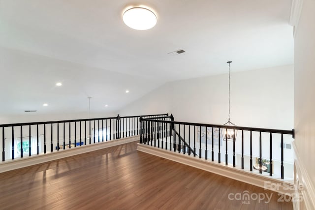 10418 Pullengreen Dr, Charlotte, NC 28277 - hallway featuring wood finished floors, a chandelier, recessed lighting, and lofted ceiling