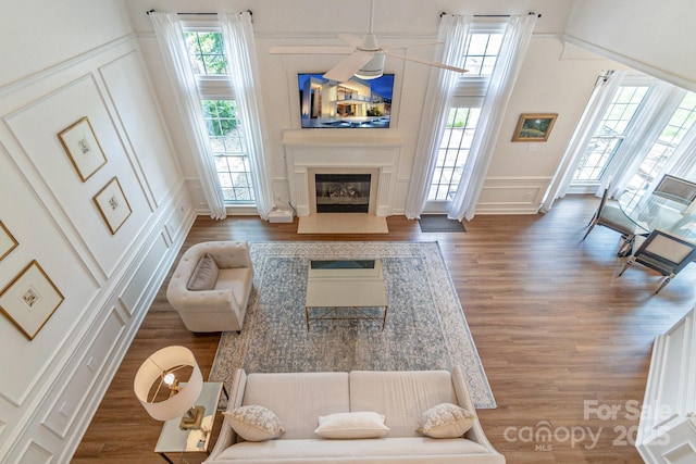 10418 Pullengreen Dr, Charlotte, NC 28277 - living room with a decorative wall, wood finished floors, a glass covered fireplace, and a wainscoted wall
