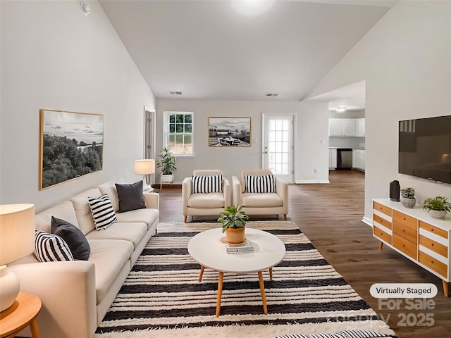8219 Pozzi Rd, Charlotte, NC 28216 - living area with high vaulted ceiling and dark wood-style flooring