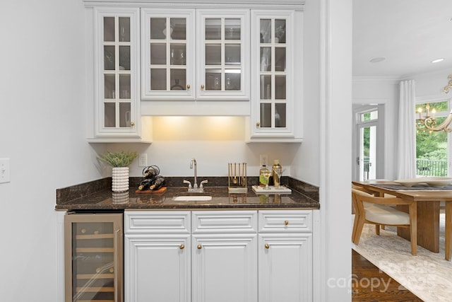 7912 Baltusrol Ln, Charlotte, NC 28210 - indoor wet bar with wine cooler, ornamental molding, and a chandelier