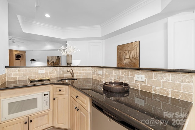 7912 Baltusrol Ln, Charlotte, NC 28210 - kitchen with a raised ceiling, decorative backsplash, dark stone countertops, crown molding, and white microwave
