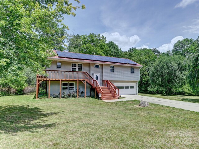 14 Spring Lake Dr, Fletcher, NC 28732 - split foyer home with stairway, an attached garage, driveway, and solar panels