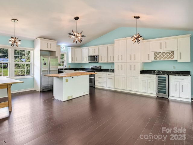 14 Spring Lake Dr, Fletcher, NC 28732 - kitchen with stainless steel appliances, beverage cooler, wood counters, vaulted ceiling, and dark wood-style floors