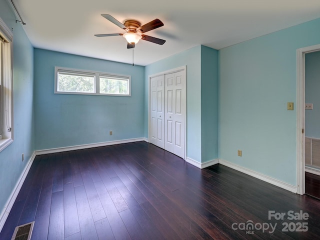 14 Spring Lake Dr, Fletcher, NC 28732 - unfurnished bedroom with dark wood-style floors, a closet, and a ceiling fan