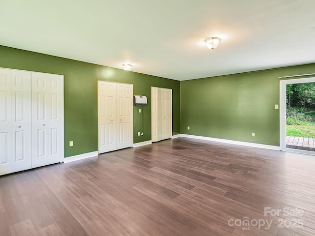 14 Spring Lake Dr, Fletcher, NC 28732 - unfurnished bedroom featuring multiple closets, access to outside, and dark wood finished floors