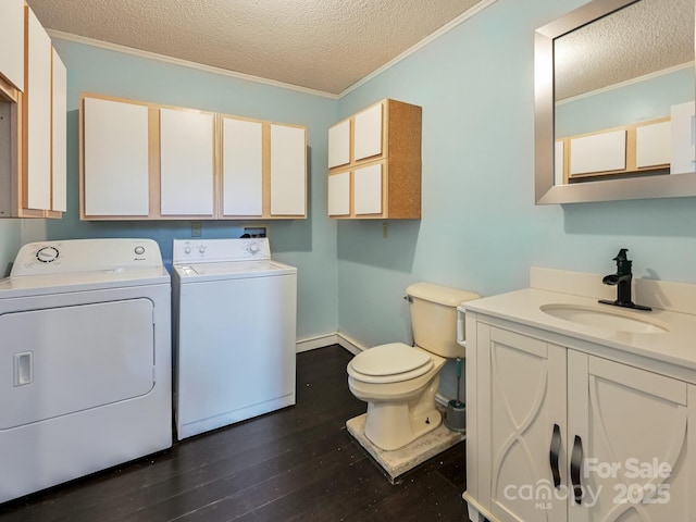 14 Spring Lake Dr, Fletcher, NC 28732 - washroom featuring washing machine and clothes dryer, a textured ceiling, crown molding, and dark wood-style flooring