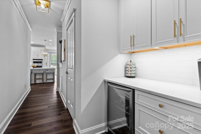 615 N Oak Dr, Huntersville, NC 28078 - bar featuring beverage cooler, decorative backsplash, dark wood-type flooring, recessed lighting, and stainless steel double oven
