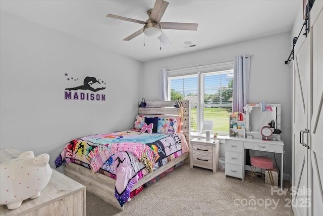 615 N Oak Dr, Huntersville, NC 28078 - bedroom with light colored carpet, a barn door, and a ceiling fan