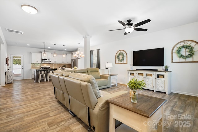 5069 Thomasville Dr, Belmont, NC 28012 - living area with light wood-style floors, a ceiling fan, a chandelier, and recessed lighting
