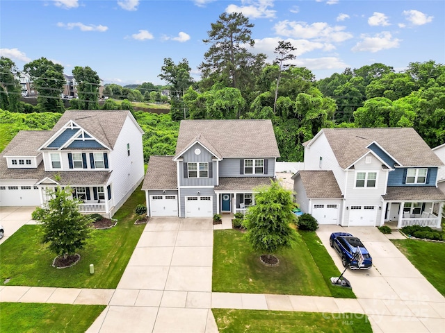 5069 Thomasville Dr, Belmont, NC 28012 - view of front of property with board and batten siding, concrete driveway, and a front lawn