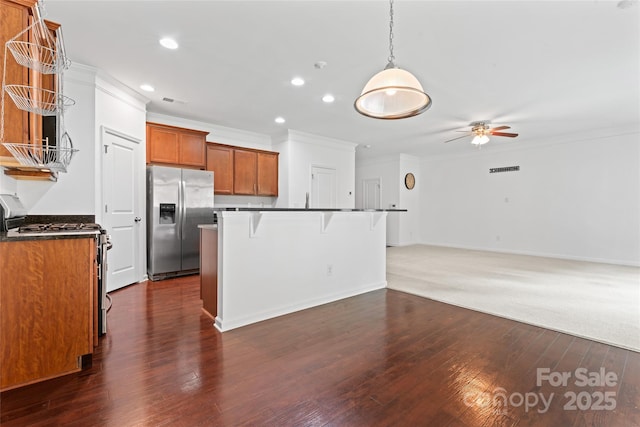 231 Anvil Draw Pl, Rock Hill, SC 29730 - kitchen with stainless steel appliances, ornamental molding, a ceiling fan, a breakfast bar area, and brown cabinetry