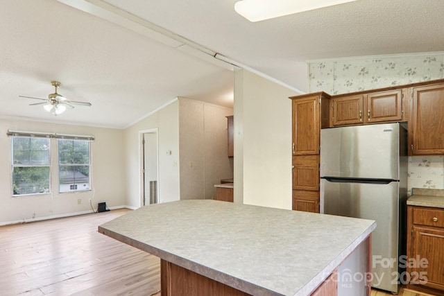 18 Sweet Briar Path Way, Hendersonville, NC 28792 - kitchen featuring freestanding refrigerator, crown molding, light wood-style floors, a ceiling fan, and a kitchen island