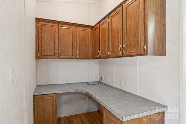 18 Sweet Briar Path Way, Hendersonville, NC 28792 - kitchen with built in study area, brown cabinetry, and wood finished floors
