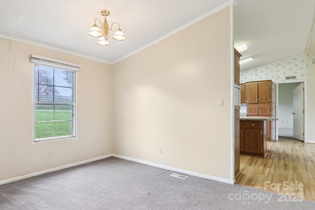 18 Sweet Briar Path Way, Hendersonville, NC 28792 - empty room with ornamental molding, a chandelier, light carpet, and vaulted ceiling