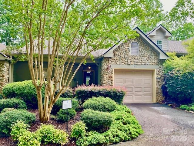 186 Stonecrest Ct, Lake Lure, NC 28746 - view of front of home featuring stone siding, a garage, and asphalt driveway