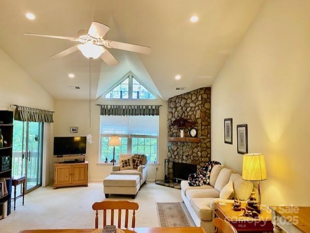 186 Stonecrest Ct, Lake Lure, NC 28746 - living area with high vaulted ceiling, light colored carpet, ceiling fan, a stone fireplace, and recessed lighting