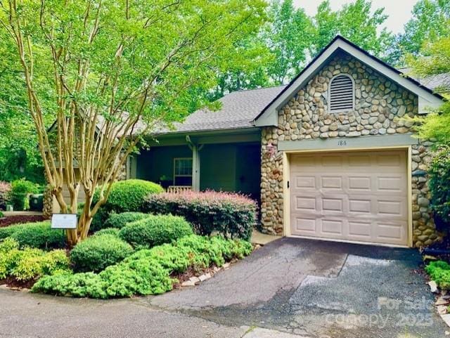186 Stonecrest Ct, Lake Lure, NC 28746 - view of front facade with stone siding, a garage, and asphalt driveway