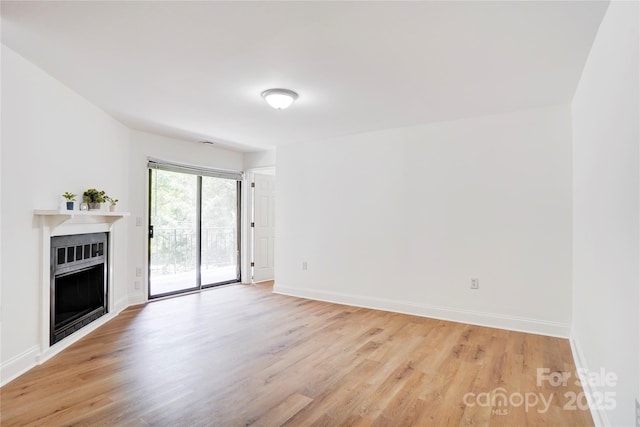 4806 Spring Lake Dr Unit D, Charlotte, NC 28212 - unfurnished living room with light wood-type flooring and a fireplace
