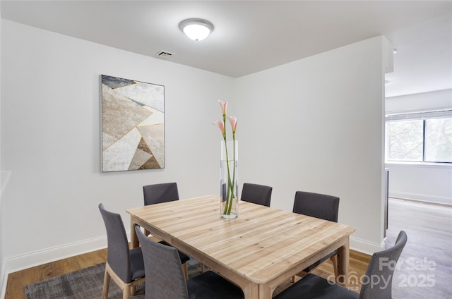 4806 Spring Lake Dr Unit D, Charlotte, NC 28212 - dining room featuring wood finished floors and baseboards