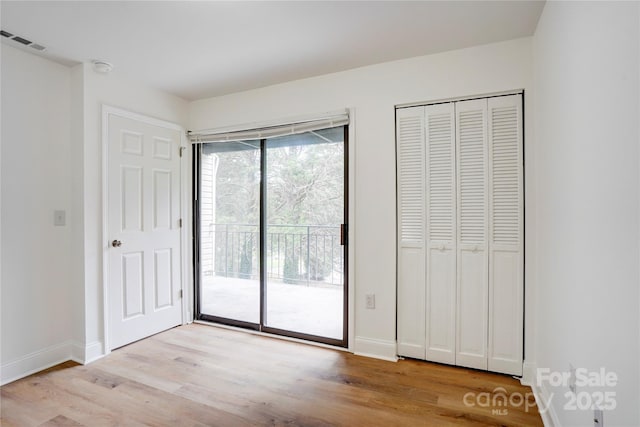 4806 Spring Lake Dr Unit D, Charlotte, NC 28212 - unfurnished bedroom featuring access to outside and light wood-style floors