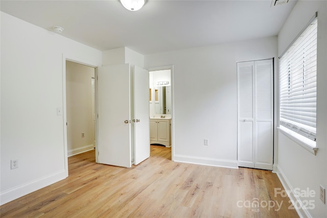 4806 Spring Lake Dr Unit D, Charlotte, NC 28212 - unfurnished bedroom with light wood finished floors, a closet, and connected bathroom