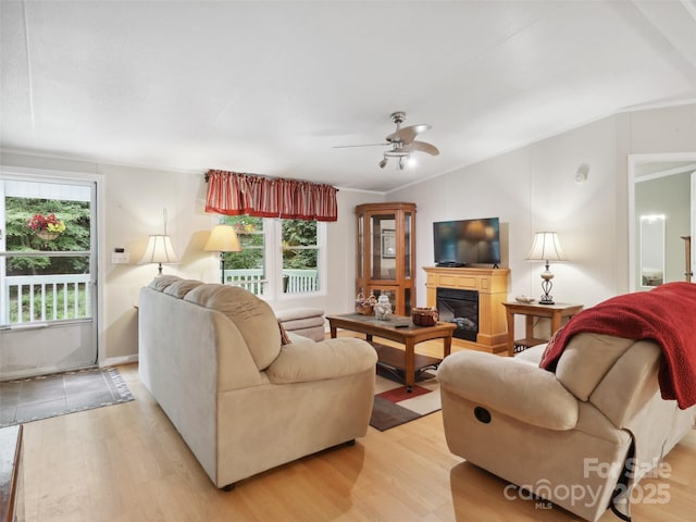 275 Bulldog Ln, Green Mountain, NC 28740 - living room with light wood finished floors, ceiling fan, vaulted ceiling, and a glass covered fireplace