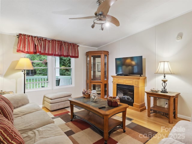 275 Bulldog Ln, Green Mountain, NC 28740 - living room with lofted ceiling, light wood-type flooring, a ceiling fan, and a glass covered fireplace