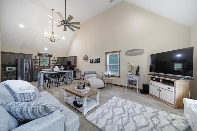 4592 Reid Rd, Edgemoor, SC 29712 - living room with high vaulted ceiling, ceiling fan, light wood-style flooring, and a chandelier