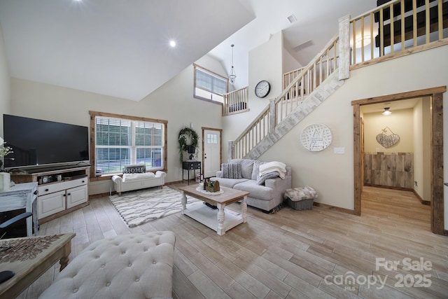 4592 Reid Rd, Edgemoor, SC 29712 - living room with high vaulted ceiling, stairway, and wood finished floors
