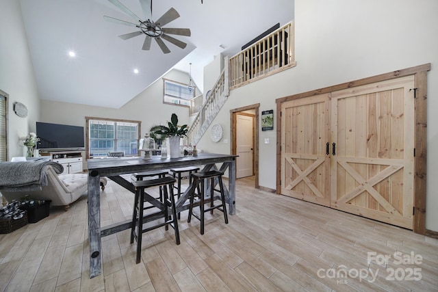 4592 Reid Rd, Edgemoor, SC 29712 - dining space featuring high vaulted ceiling, ceiling fan, light wood-style floors, and stairs