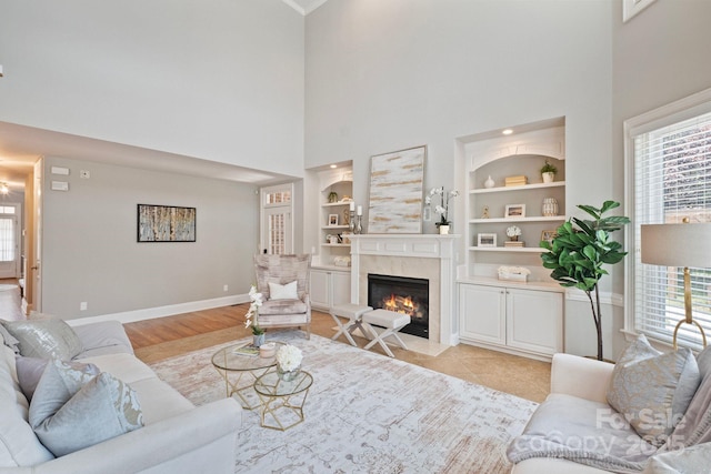 11335 Wescott Hill Dr, Huntersville, NC 28078 - living area featuring a towering ceiling, built in shelves, healthy amount of natural light, and a premium fireplace
