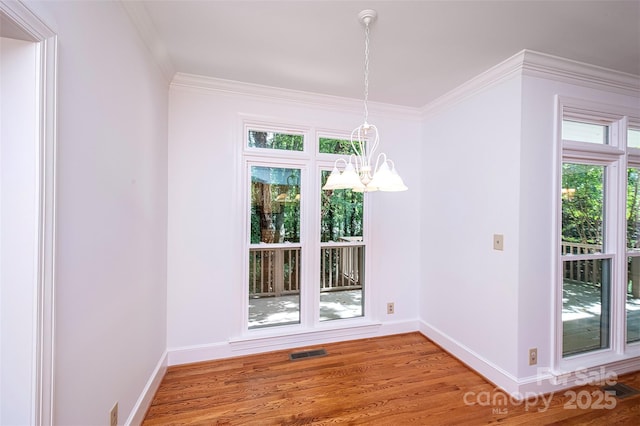 10408 Hadleigh Pl, Charlotte, NC 28210 - unfurnished dining area featuring a chandelier, crown molding, and wood finished floors