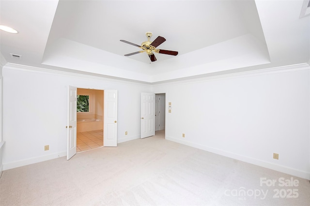 10408 Hadleigh Pl, Charlotte, NC 28210 - unfurnished bedroom with a raised ceiling, light colored carpet, a ceiling fan, and connected bathroom