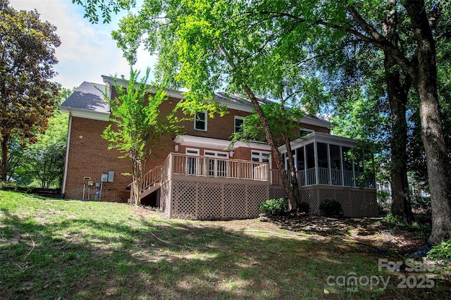 10408 Hadleigh Pl, Charlotte, NC 28210 - rear view of property featuring a sunroom, stairs, a lawn, brick siding, and a deck