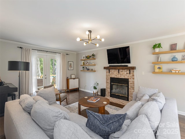 502 Windsor Forest Ct, Fletcher, NC 28732 - living area featuring dark wood-style floors, ornamental molding, a brick fireplace, french doors, and a chandelier
