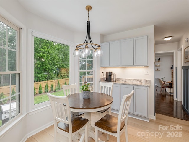 502 Windsor Forest Ct, Fletcher, NC 28732 - dining space with healthy amount of natural light, a chandelier, and light wood-style floors