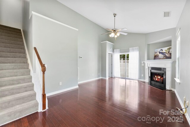 448 River Park Rd, Belmont, NC 28012 - unfurnished living room with a ceiling fan, wood finished floors, a fireplace with flush hearth, stairs, and high vaulted ceiling
